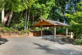 Large, covered RV parking with an RV hookup on site.