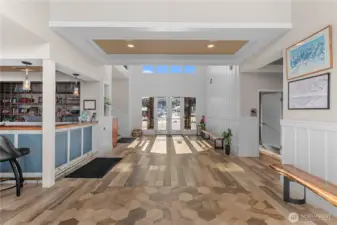 Lounge to the left (past the wet bar), restrooms, kitchen & elevator to the right.