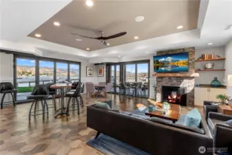 This lounge is so inviting and the big sliders on two sides lead to covered patios.  A fireplace makes watching sports all the more cozy.