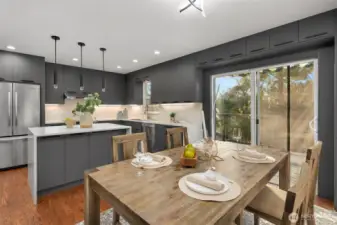 Gourmet fully renovated kitchen with abundance of high quality cabinets, SS appliances, quartz counter tops and island extends in to dining room