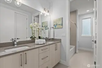 A bright and beautifully finished secondary bath with dual sinks, modern cabinetry, and clean, timeless style.