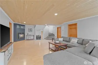 Bright and open living space with natural light, cozy gas fireplace, and warm finishes—ideal for relaxing or hosting guests in this Montesano farmhouse.