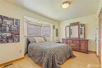 Comfortable bedroom with natural light and peaceful setting—ideal for rest and relaxation.