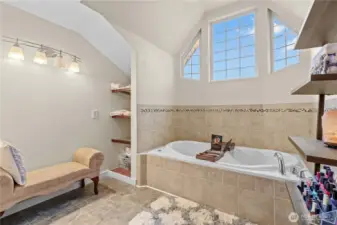 Primary bathroom featuring soaking tub, dual vanities, and functional layout for everyday comfort
