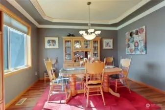 Formal dining room with crown molding, recessed ceilings and cove lighting