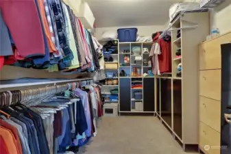 Primary walk in closet with tons of storage space