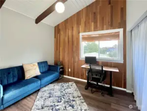 Bedroom #2, upper level, currently being utilized as an office, is also just off kitchen.  Check out that natural solid wood paneling.  Furnishings in this room can be included in the sale of the home.