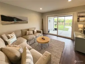 Main level Living room has direct access to the back yard through an oversized slider door.  Appreciate new can lighting & easy maintenance luxury vinyl floors.