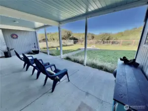 Covered patio with backyard and beach bluff views.