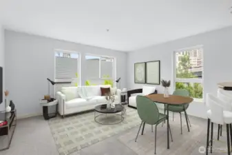The spacious living room features lots of natural light and views of bright green ginko trees