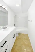Full bathroom with updated vanity, shower, and fixtures.
