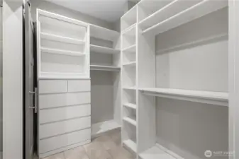Walk-in closet with organizers in the main-floor primary suite.