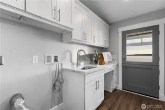 Laundry with custom cabinets & door to the patio. Even laundry day gets a view!