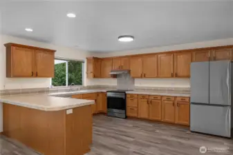 This kitchen is huge! In addition to the cabinet and counter storage, there's an oversized walk-in pantry next to the door to the formal dining room. Solid wood cabinetry, a custom tile counter and backsplash, and all new appliances create a kitchen where daily chores become simple.