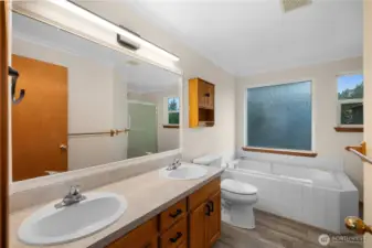The primary bathroom includes dual vanities, a soaking tub and a separate shower.