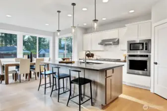 Kitchen and eating nook. Features stainless steel KitchenAid appliances. Pictures depict a previously built home similar to the home going to be built on this lot. Floor plans, Elevations, colors, upgrades & materials may be different.