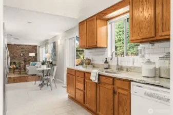 Wide kitchen with wood cabinetry and quartz counter tops