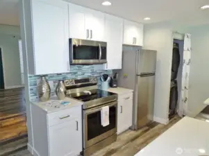 Kitchen w/ beachy-tile backsplash.