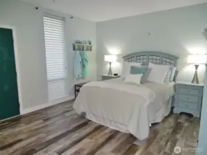 Entry into this Open Bedroom. Beautifully remodeled w/ vinyl-plank flooring through-out (w/ cork underlayment).  NOTE: They changed out the headboard.