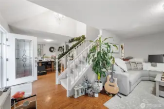 The entry splits the Living Room to the right, and the dining room and kitchen to the left. Upstairs are two bedrooms and a full bath.
