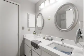 Main floor full bathroom with dual sinks; the pocket door on the left flows through the walk-in closet to the Primary bedroom...on the main floor!