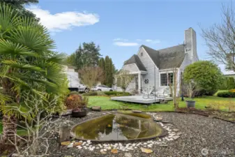 A second water feature in the front yard near the uncovered deck.