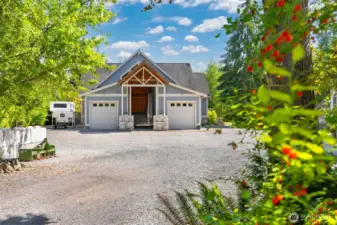 The covered entry with the full-size garages on either sides is so welcoming and well defined. There is plenty of room to park multiple vehicles or have large trucks and trailers turn around.