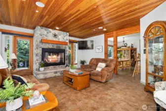 Once inside you will see the attention to detail, with the wood lined ceilings, heated tile floors, an a wood burning fireplace with actual rock surround.