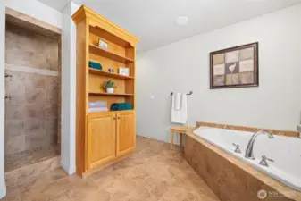 The primary bath is all done with natural tile and has a large, doorless shower with to shower heads (one is a rain shower head).