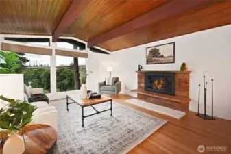 Living room with huge windows and wood burning fireplace