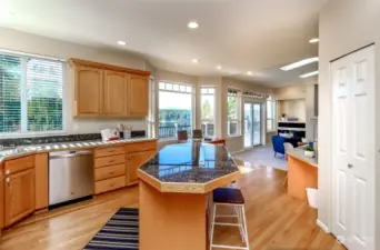 The kitchen offers a downdraft stove top island area with extra seating for helping hands.