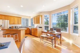 Large picture windows accentuate the beautiful view across this entire kitchen, eating area and fireside great room.