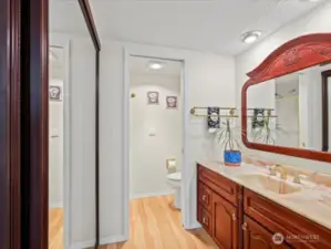 Close up view of primary bathroom. Pocket door separating the shower and toilet.