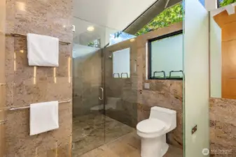 Spacious walk-in shower with dual shower heads.