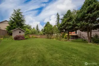 The tool shed is located in the back of the lot.