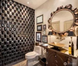 The wall of raised glass tiles shimmers.
