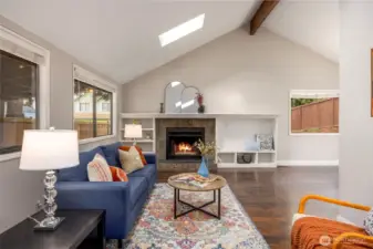 Living room with wood burning fire place and built ins.