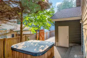 Hot tub and door to access the garage and lower level of the house.