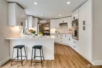 All new, high quality appliances fit right in with this open, eat-in kitchen's new cabinets and quartz countertops.
