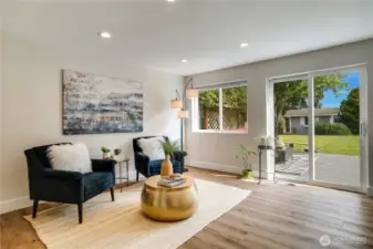 A lounge area perfect for another dining spot or cozy family room adjoins the kitchen. Sliding glass doors open to the deck and fenced back yard.