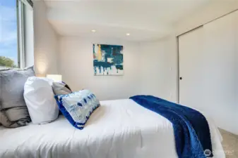 Find this updated 2nd bedroom overlooking the back yard. Sliding doors cover a good-sized closet space.