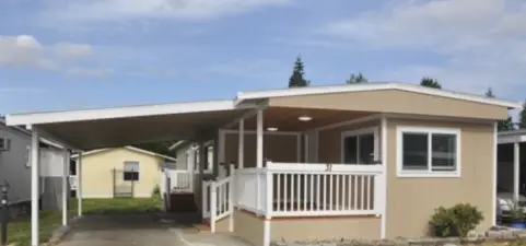 Step into the home through a lovely patio entrance, just off the covered carport.