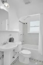 Bath offers pedestal sink and tile flooring.