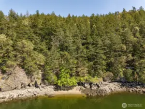 Sandy pocket beach in the center - rocky water access to the right