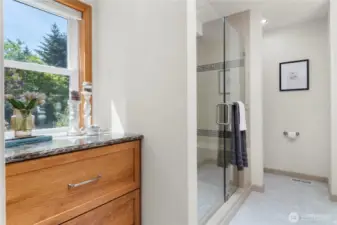 Primary bathroom & walk-in closet fully updated with beautiful pecan cabinetry, tile & quartz. Views of the garden!