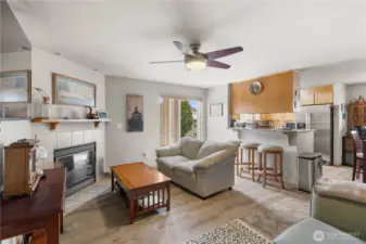 Living room with fireplace and ceiling fan.