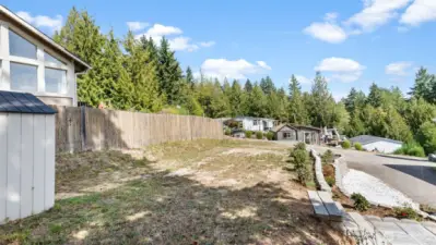 Back yard area behind the home with a shed.