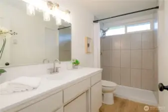modern design main floor full bathroom w/ oversized vanity and new walk in tiled shower