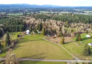Lundeen rd in the foreground showing driveway into property.