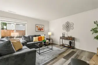 Living room looks out to fully fenced backyard